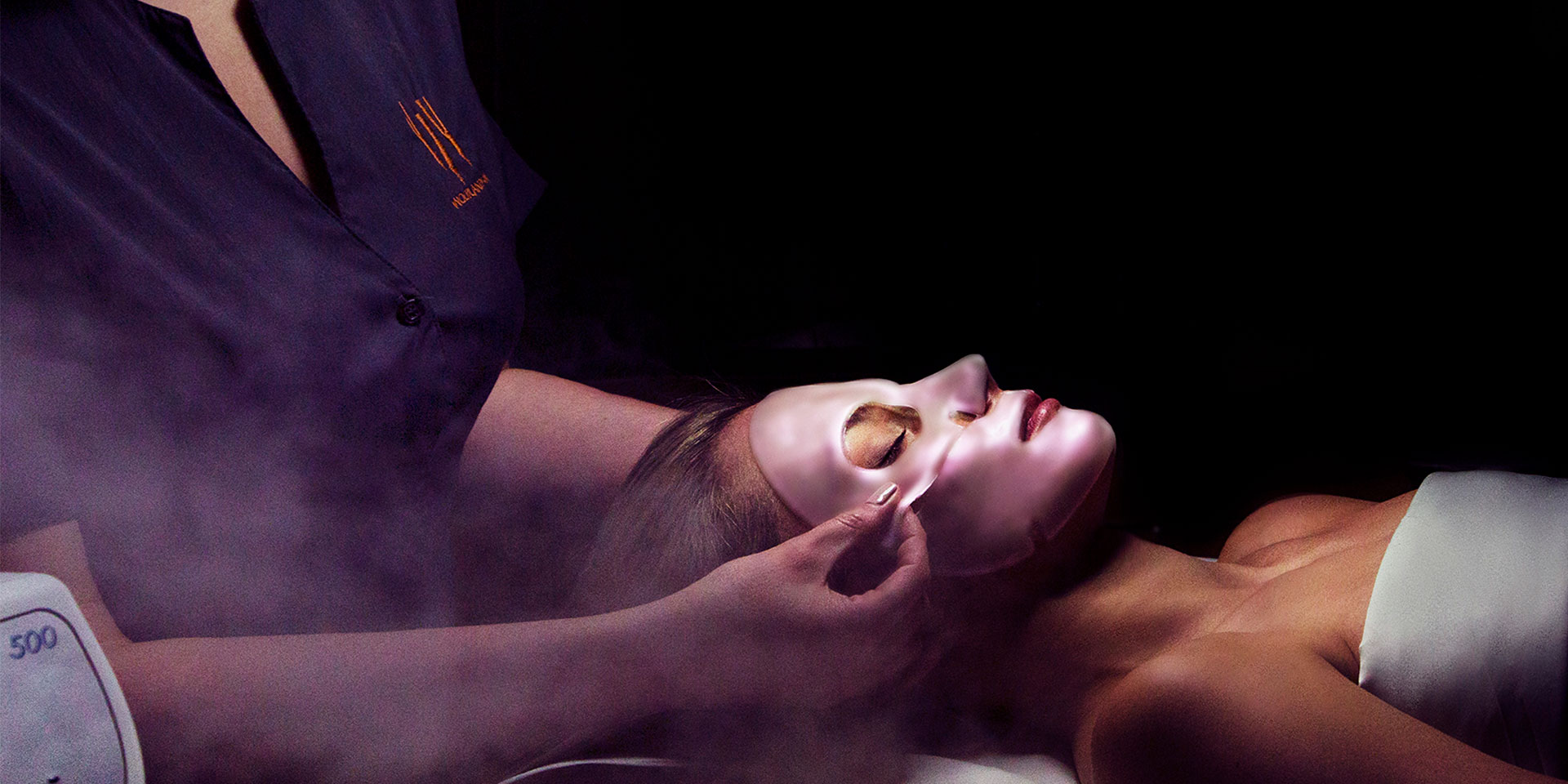 a woman receiving a face mask during her spa.