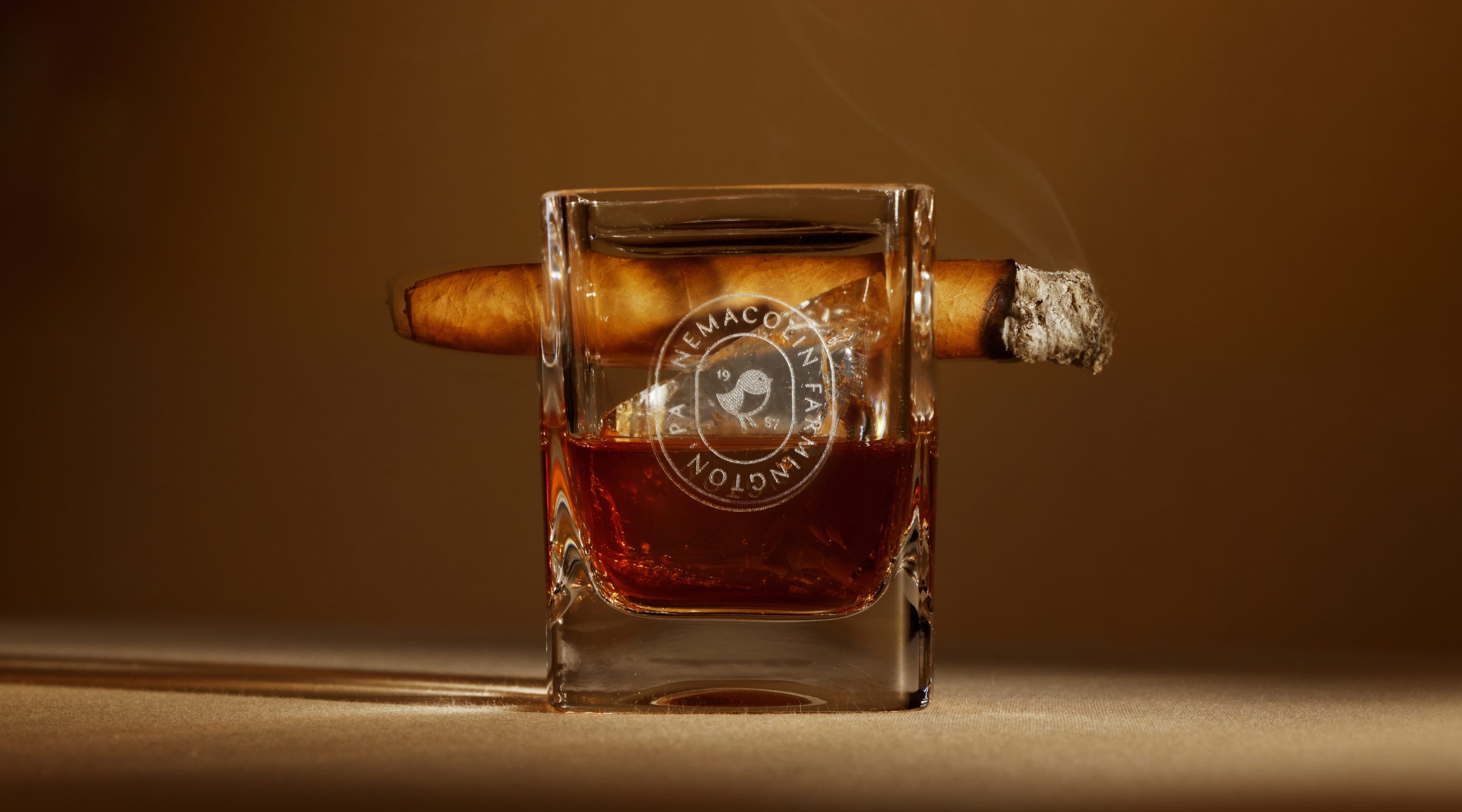 whiskey and cigar glass with Nemacolin logo