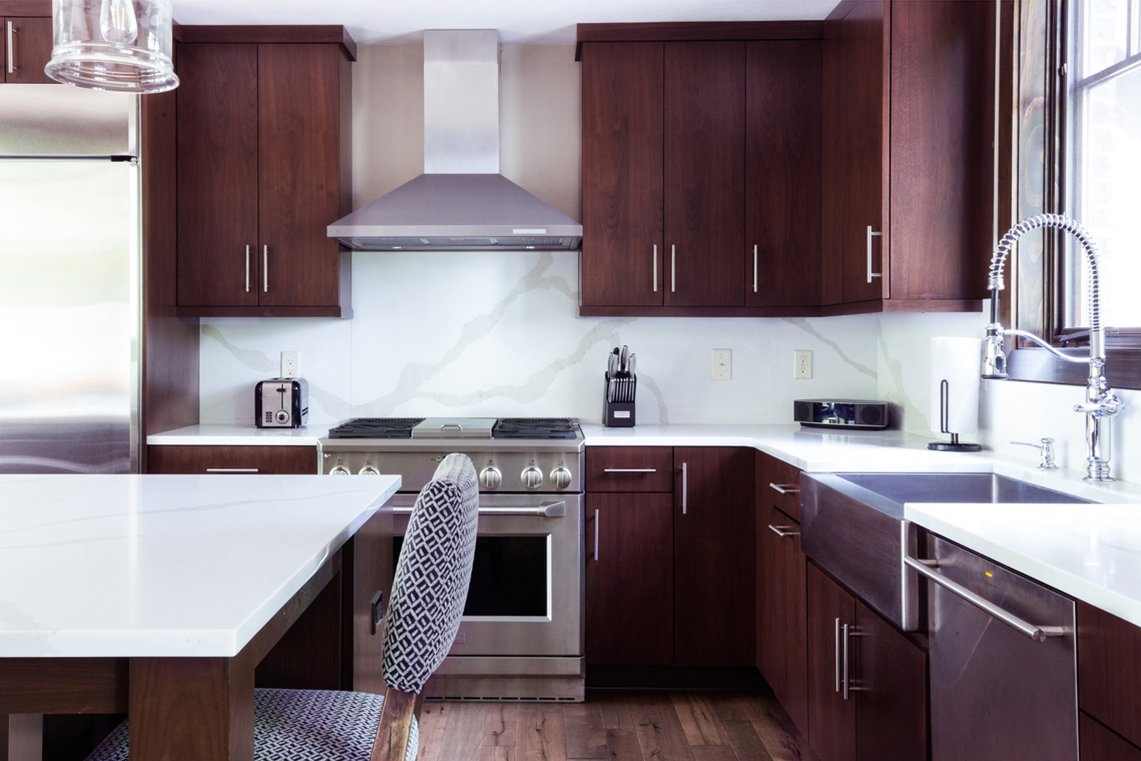 Inside shot of the kitchen, with wooden finishes and oven