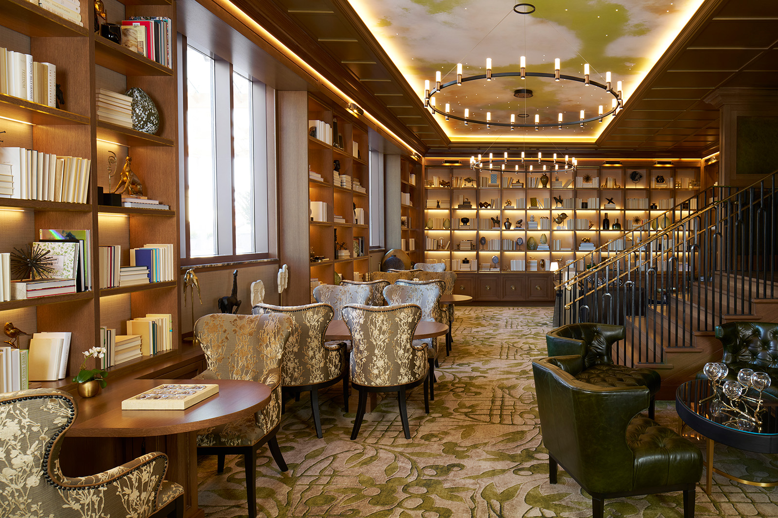 A cozy library within The Grand Lodge, featuring floor-to-ceiling bookshelves and comfortable seating, perfect for reading or quiet reflection.