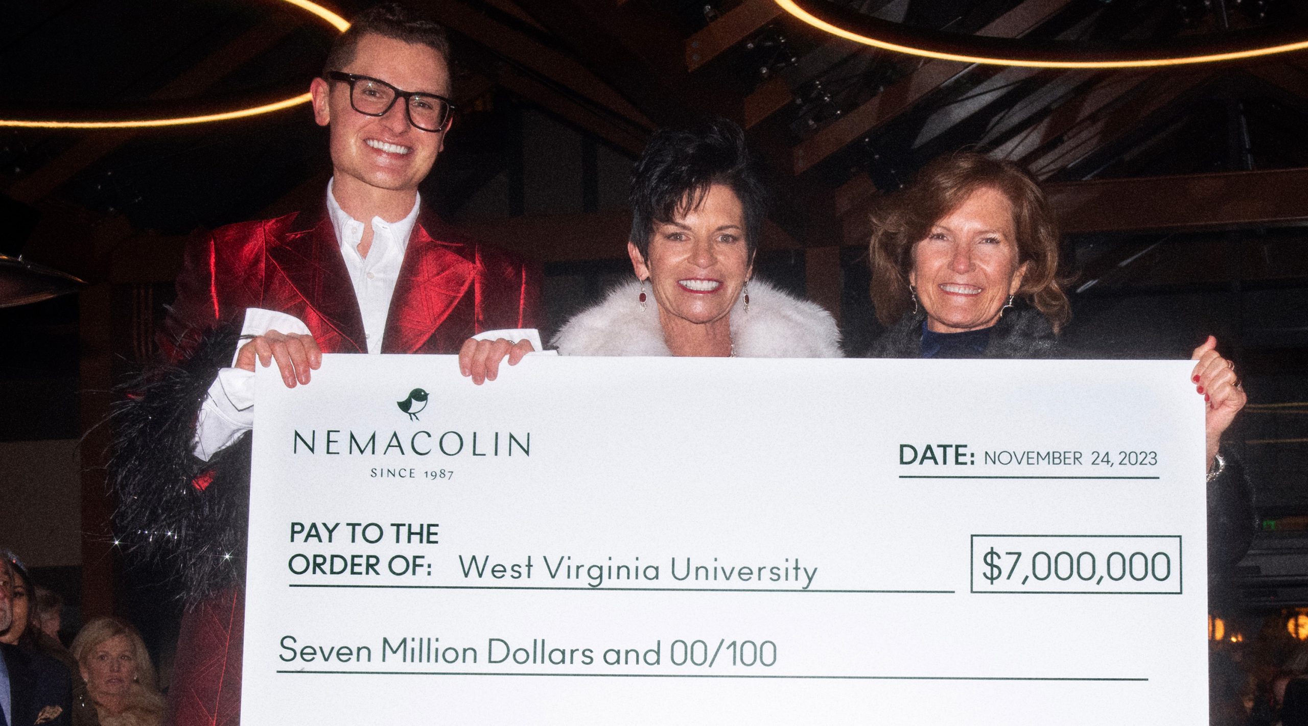 Photo of Nemacolin VP of Brand Strategy PJ Magerko Liquorice, Nemacolin Owner & CEO Maggie Hardy, and WVU Foundation President & CEO Cindi Roth with a large check and a $7 million donation