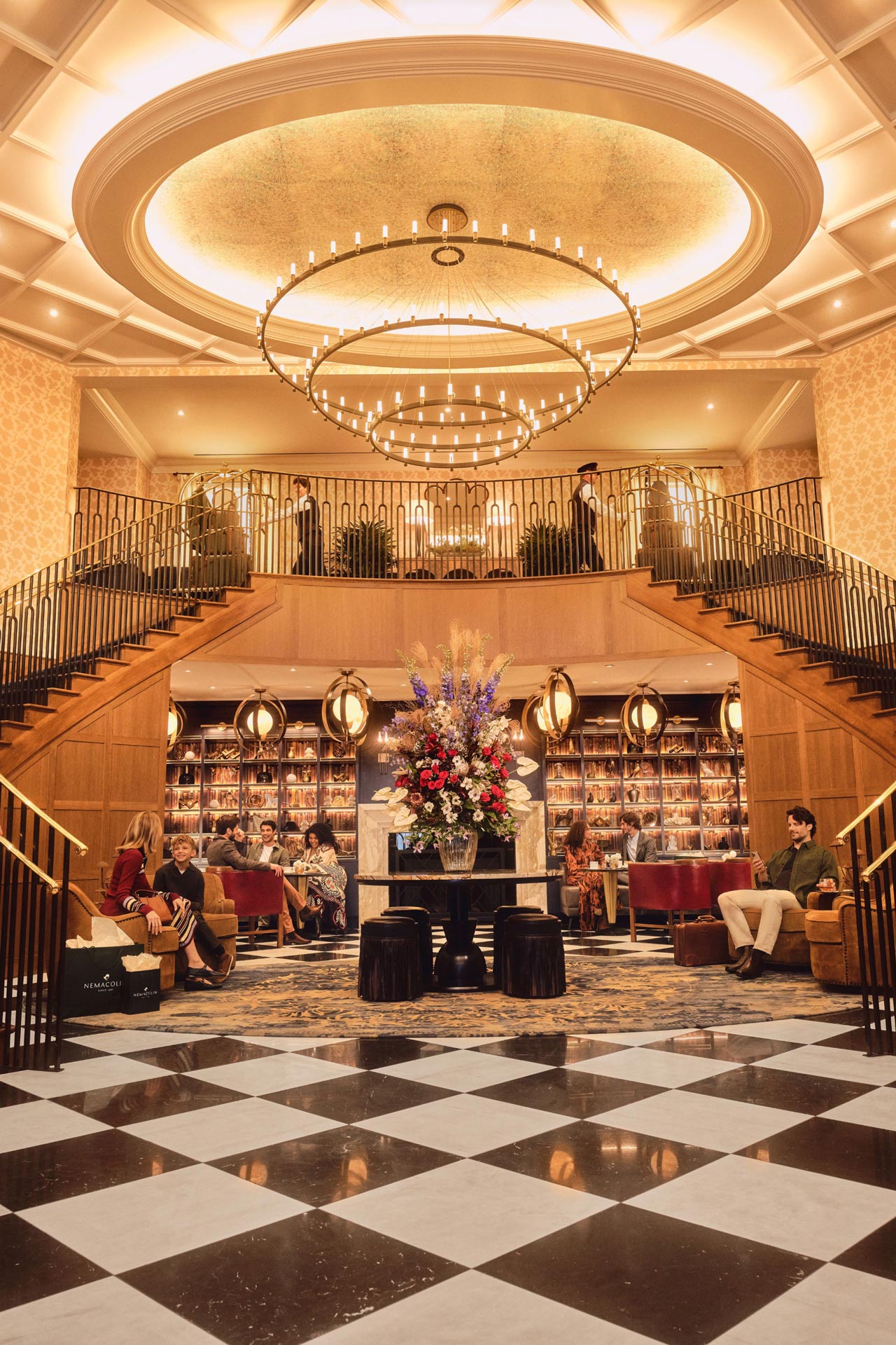 Open gallery overlay: the grand lodge lobby with black and white floor and very large chandelier with stair cases on either side