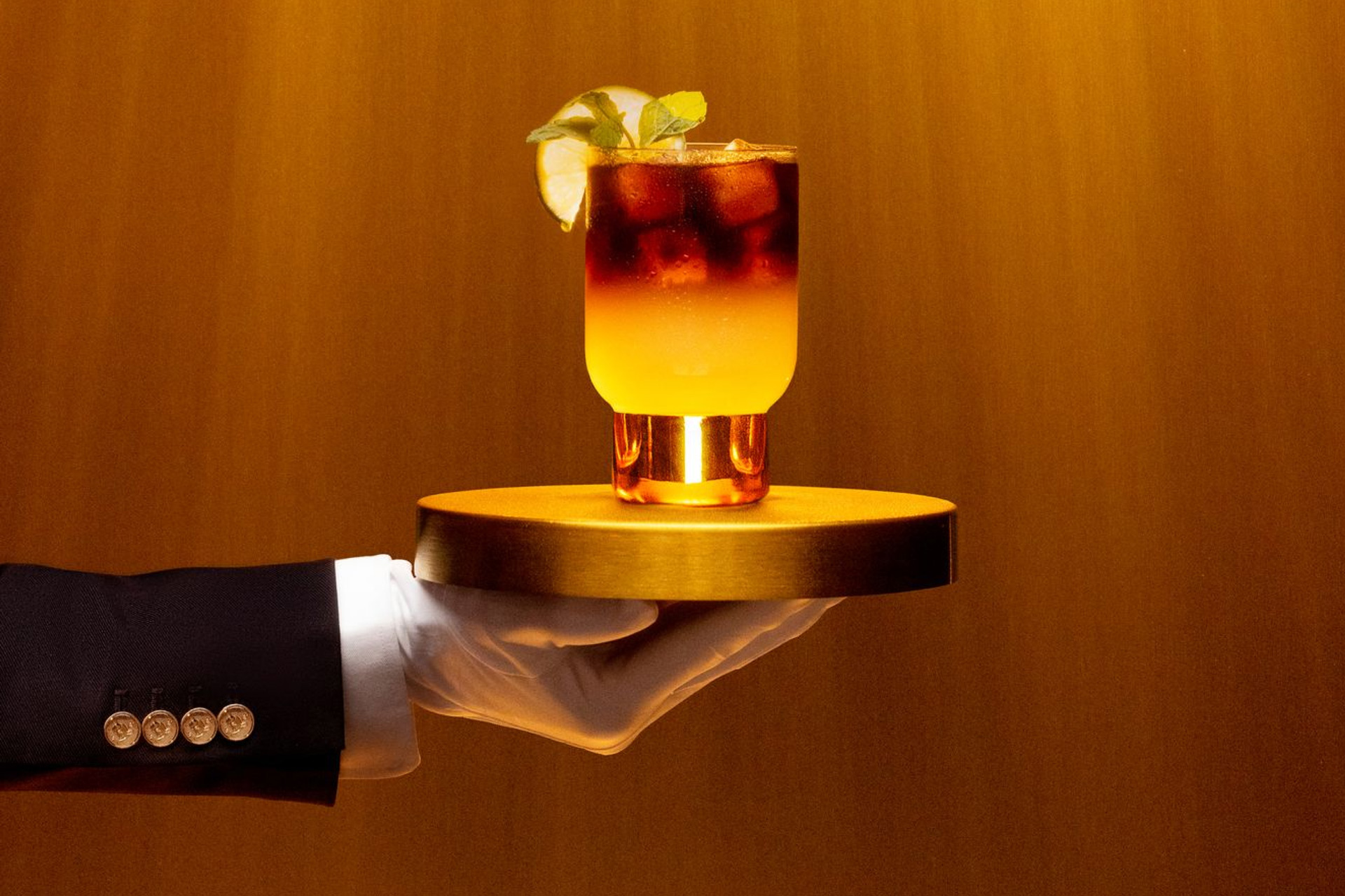 Open gallery overlay: butler's hand holding out a delicious drink on a tray