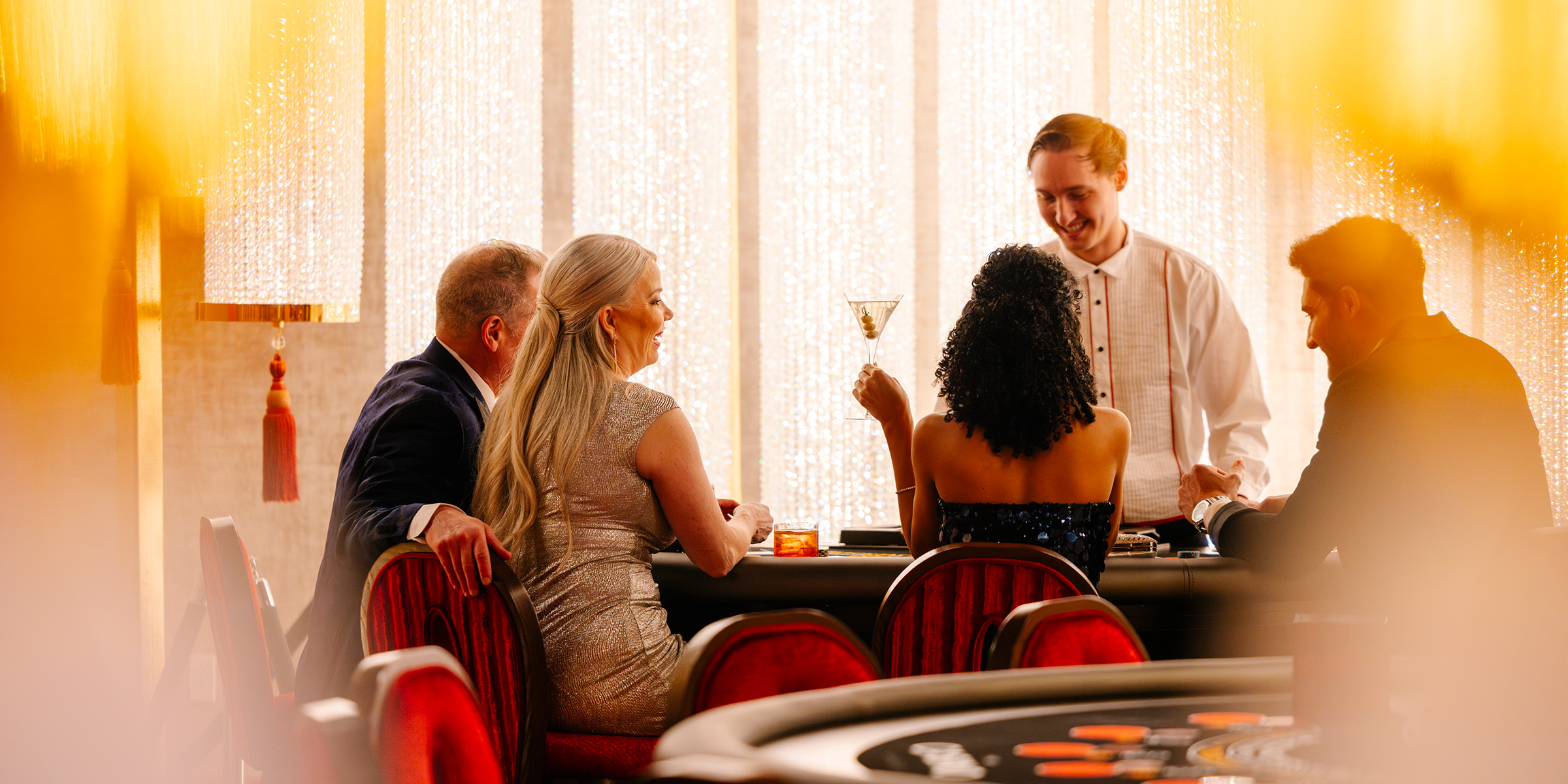 people at a card table in a casino